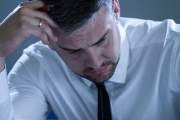 Exhausted businessman working at office
